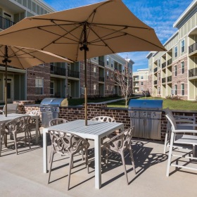 Take advantage of all The Averly at Flowers has to offer a patio with grills tables and chairs
