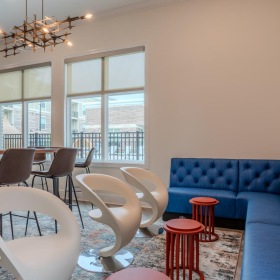 Access to resident-only features a living room with a blue couch and a table